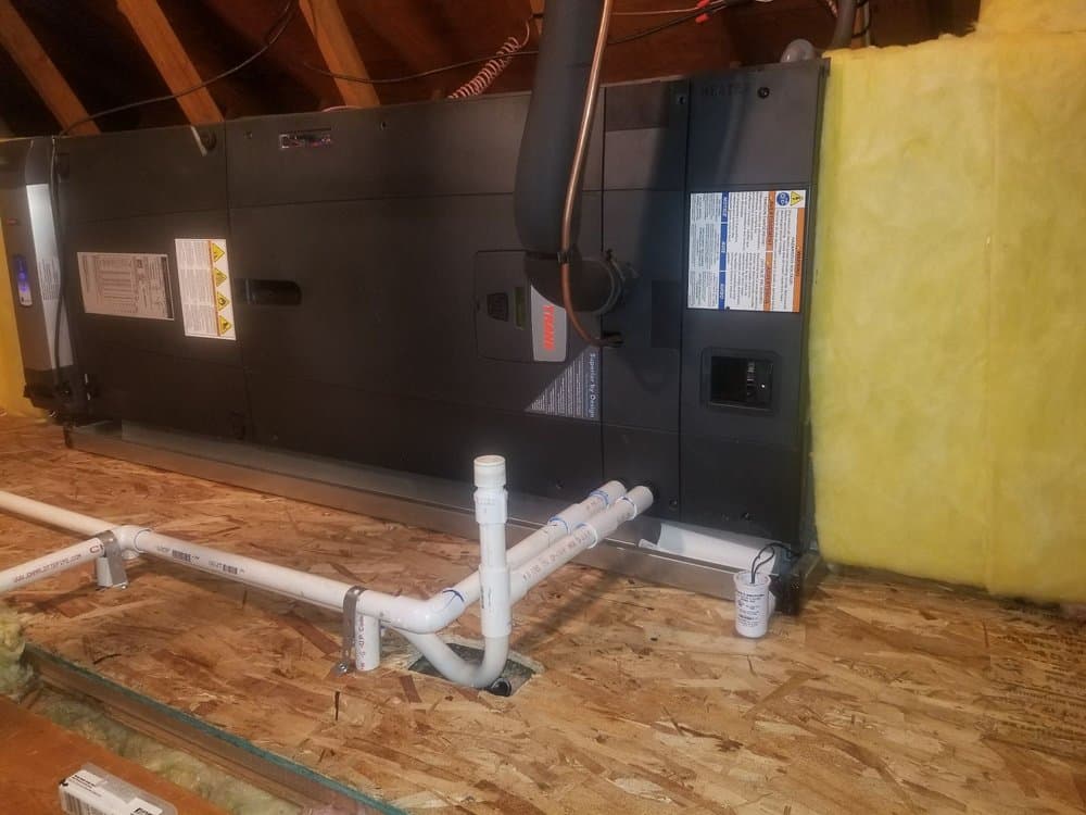 An air handler and condensate lines installed on an attic platform