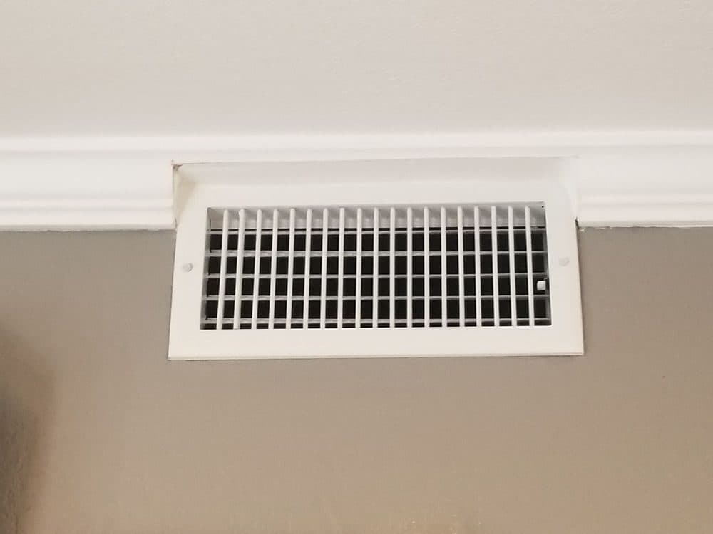A ceiling supply register in a finished room