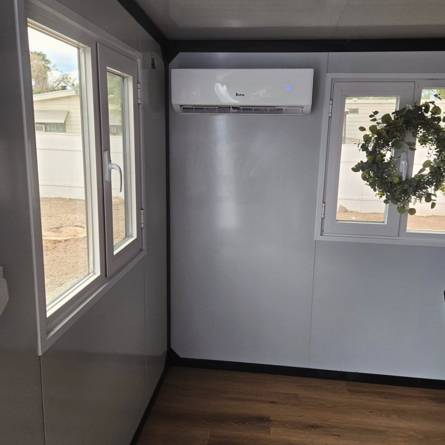 The matching wall head mounted high on the interior wall between two windows, reading 78 on its display
